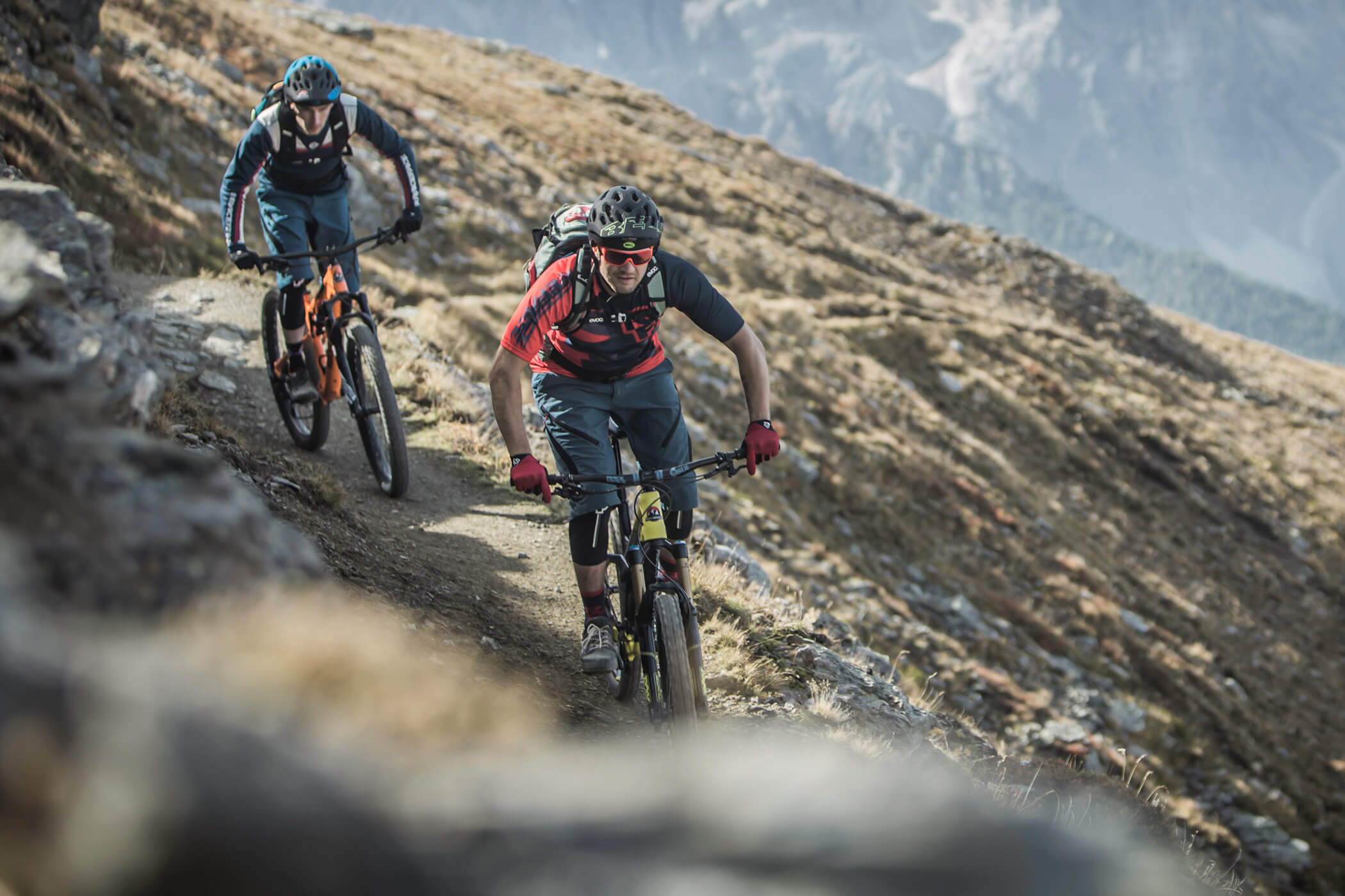 Two cyclists on a narrow cycle path in the Dolomites - Laurin's
