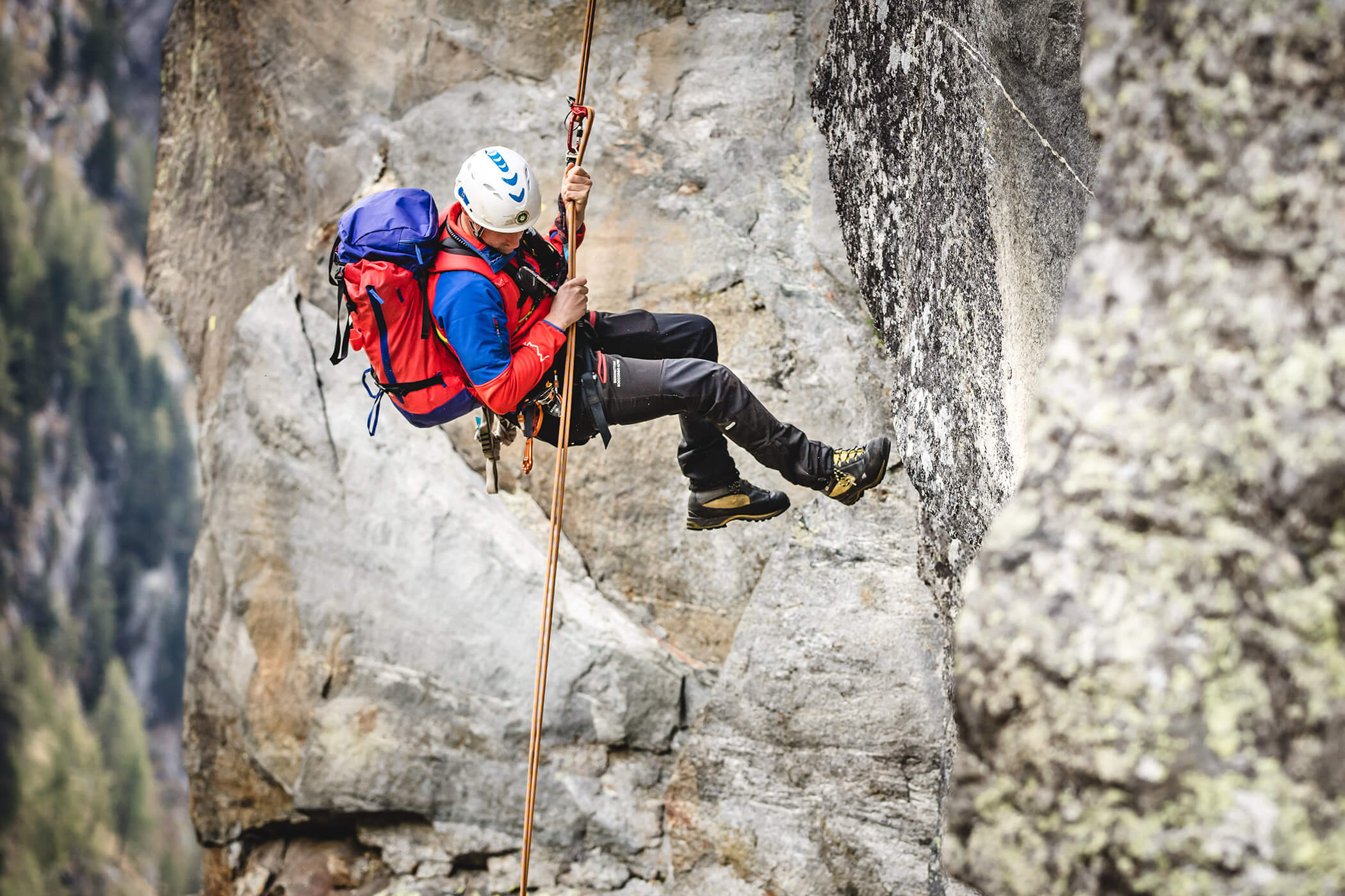 A climber abseiling down an alpine hike in the Dolomites - Laurin's